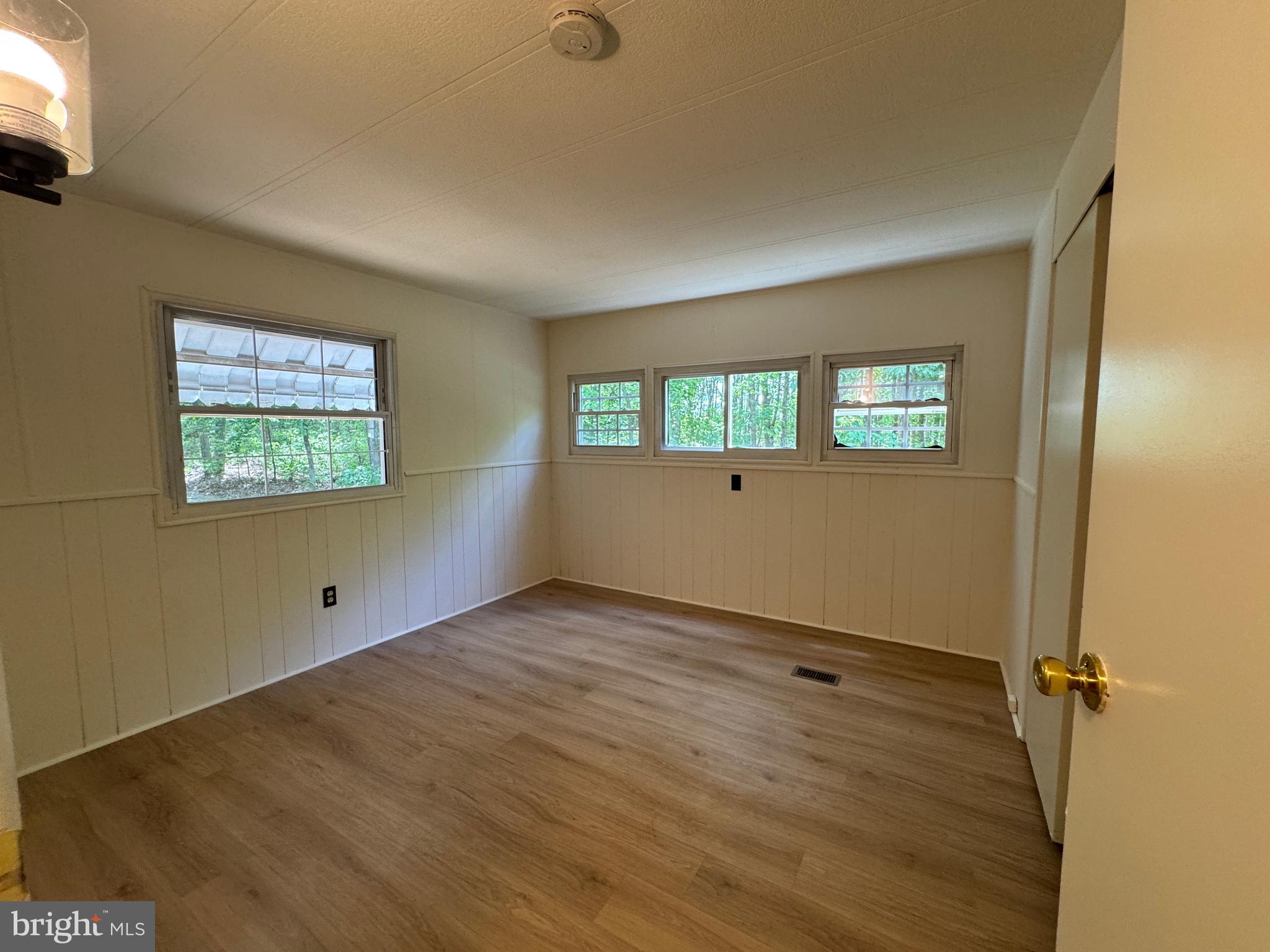 9216 Lawyers Road Spotsylvania, VA 22551 - Photo 11 of 19 wooden floor in an empty room with a window