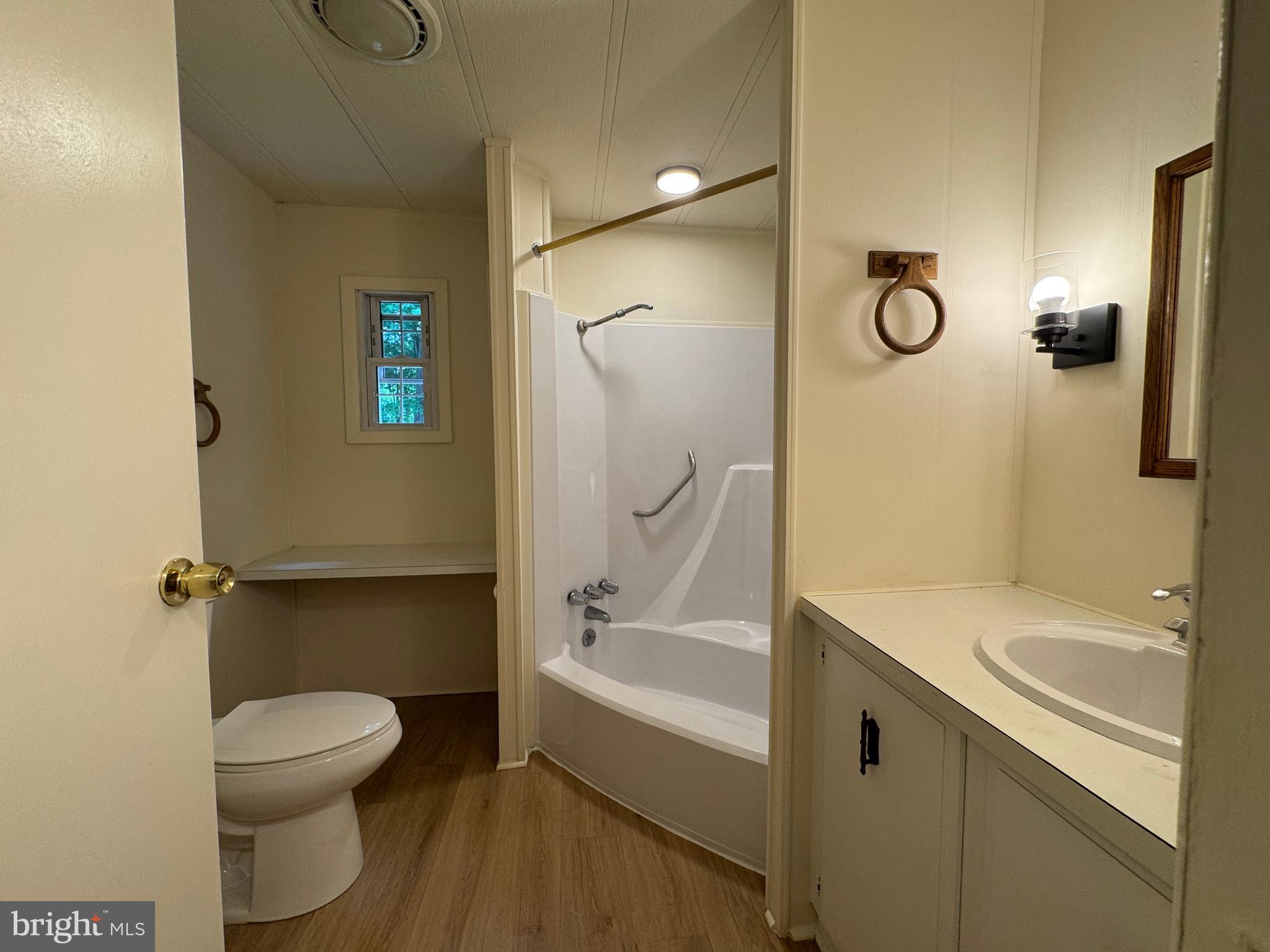 9216 Lawyers Road Spotsylvania, VA 22551 - Photo 14 of 19 a bathroom with a sink a toilet and shower