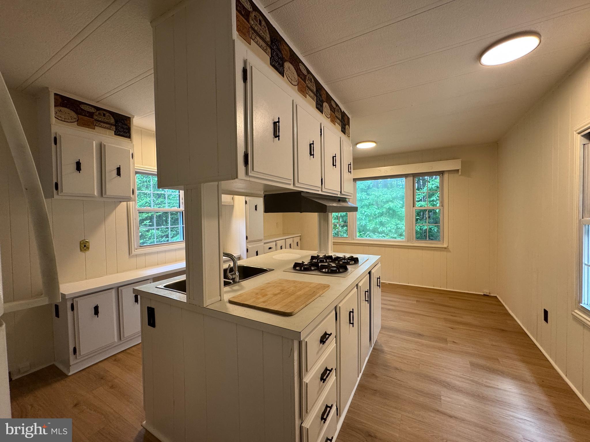 9216 Lawyers Road Spotsylvania, VA 22551 - Photo 5 of 19 a kitchen with granite countertop a stove sink and cabinets