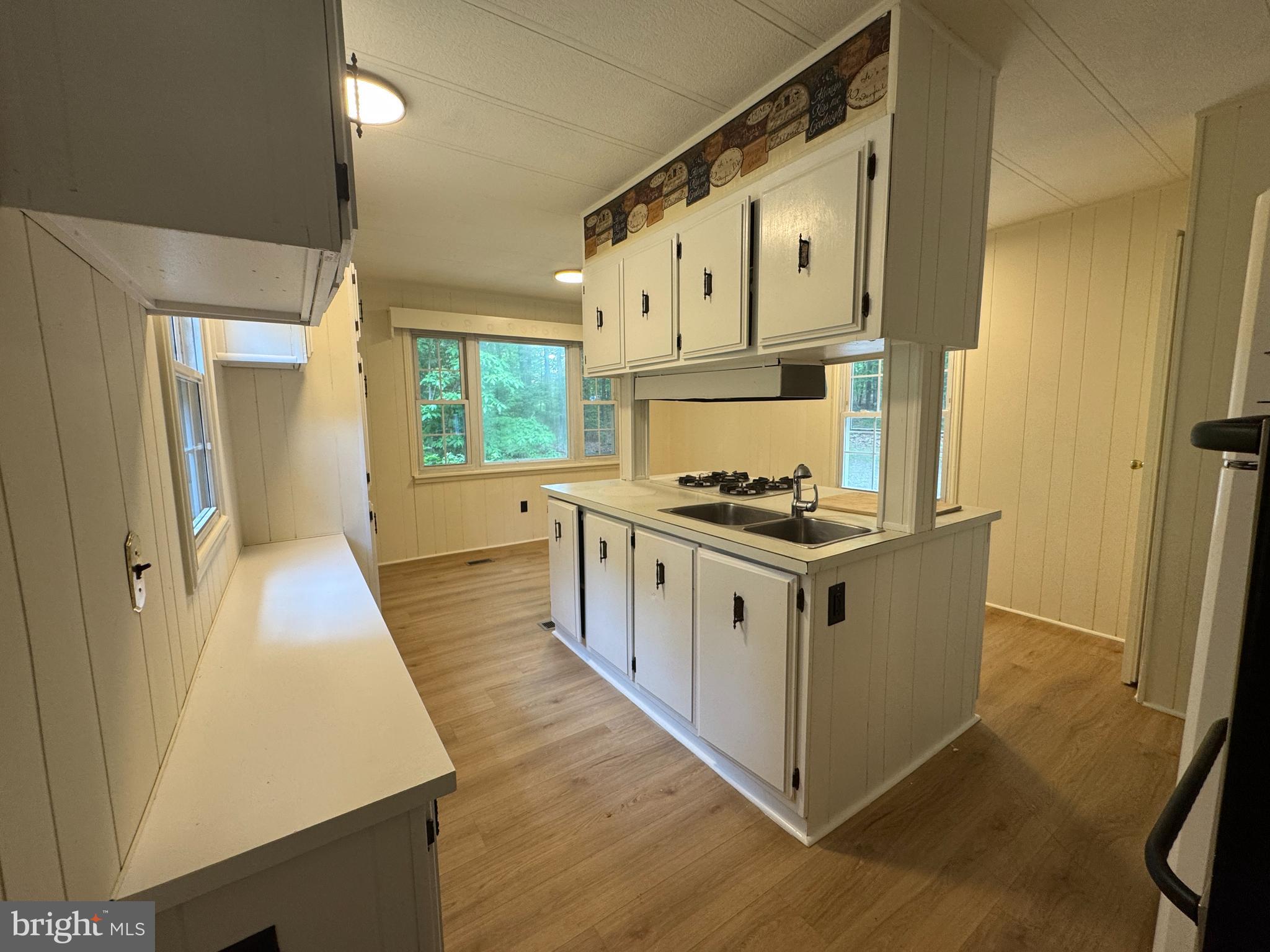 9216 Lawyers Road Spotsylvania, VA 22551 - Photo 8 of 19 a kitchen with white cabinets and white appliances