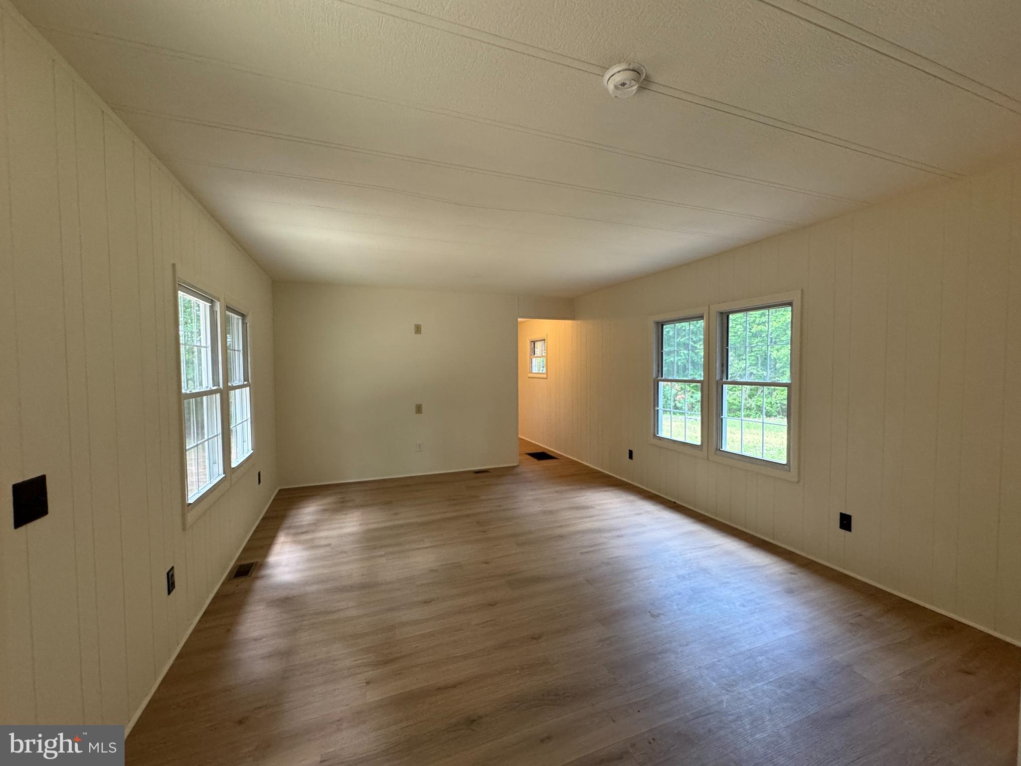 9216 Lawyers Road Spotsylvania, VA 22551 - Photo 9 of 19 an empty room with wooden floor and windows