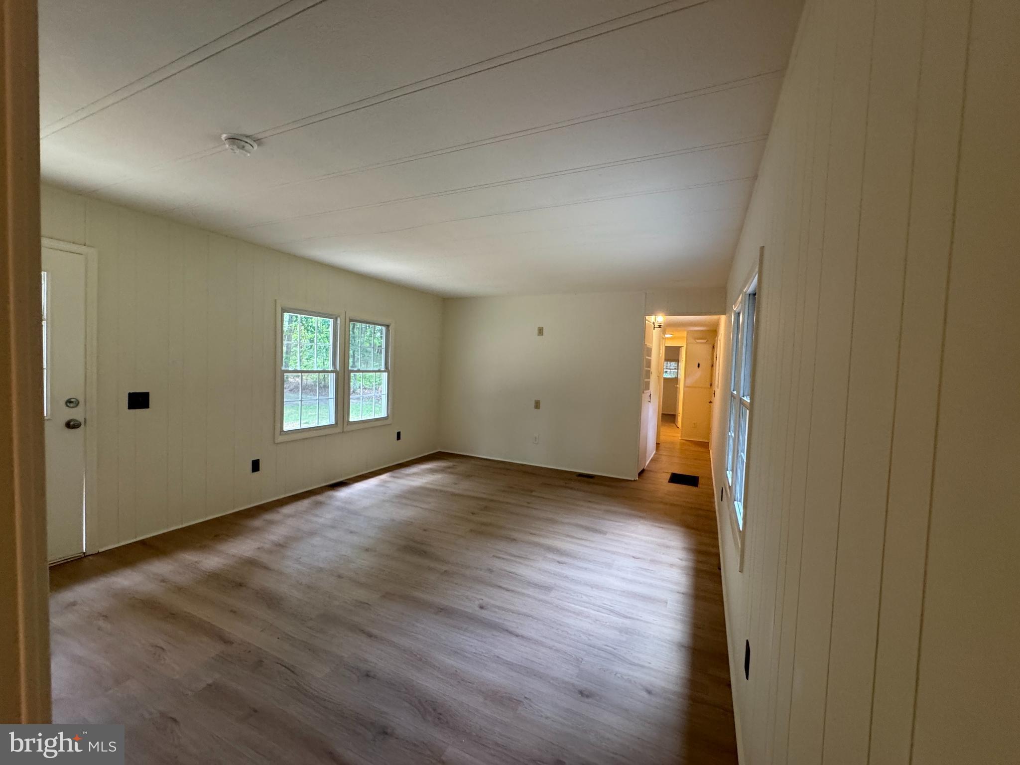 9216 Lawyers Road Spotsylvania, VA 22551 - Photo 10 of 19 an empty room with wooden floor and windows