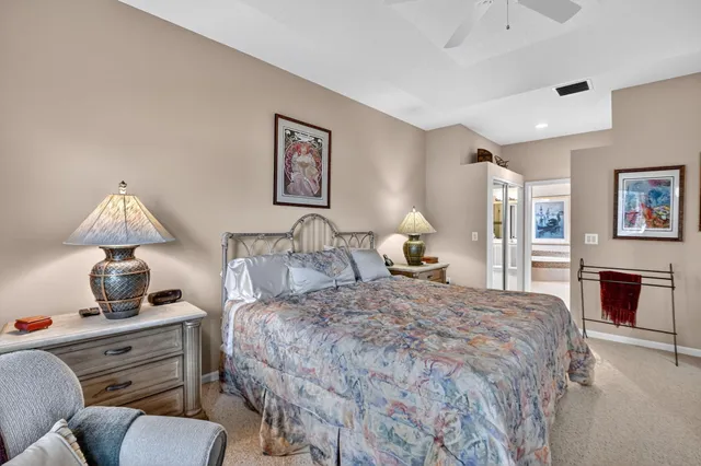 a spacious bathroom with a tub a double vanity sink a window and a mirror