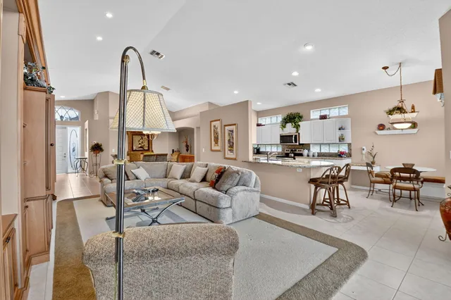 a dining room with furniture a chandelier and window