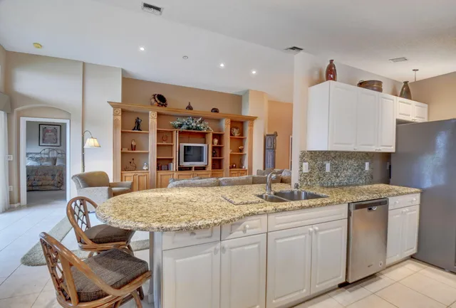a kitchen with sink refrigerator and stove