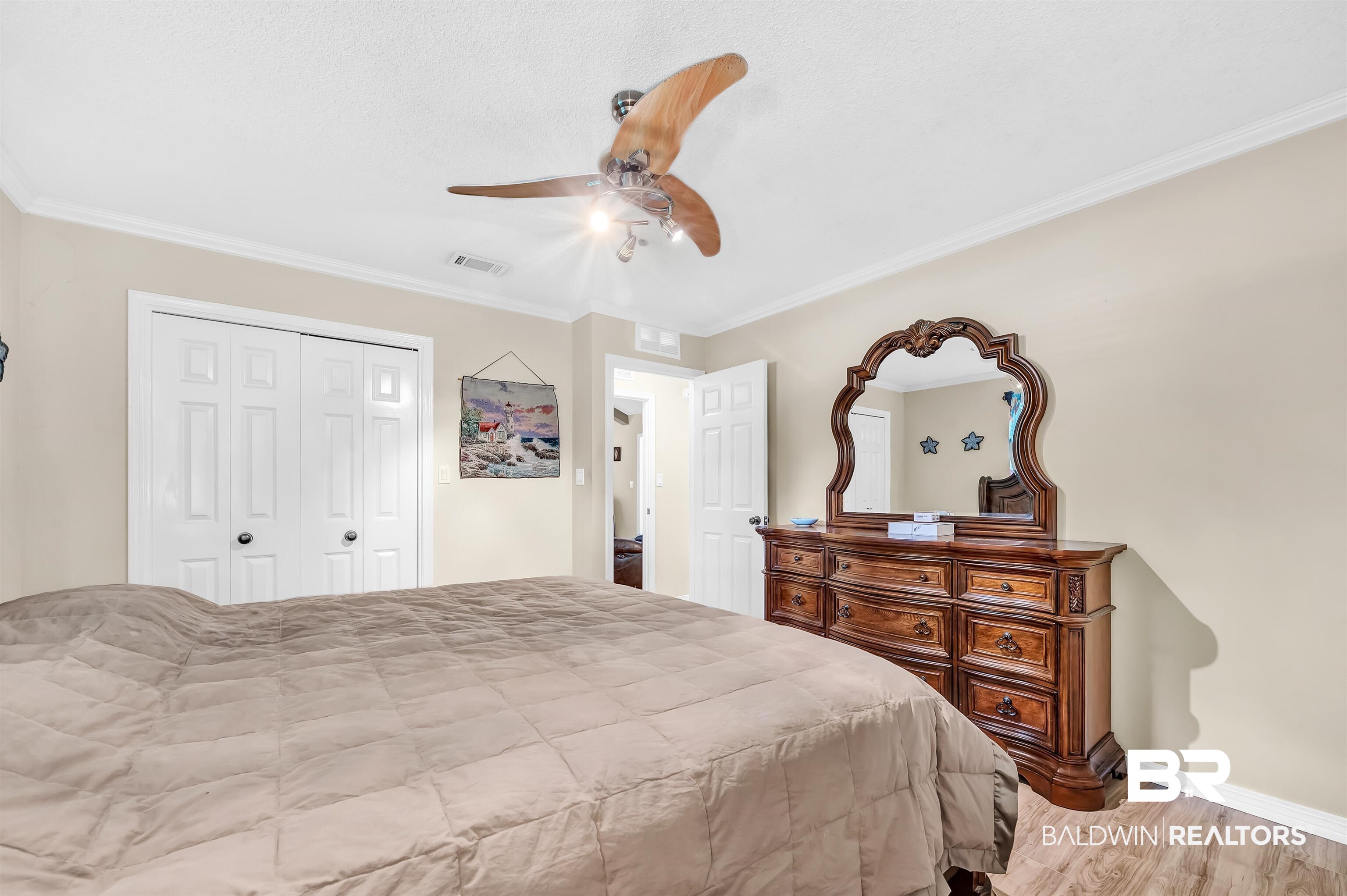 24551 Wolf Bay Drive Foley, AL 36535 - Photo 48 of 59 Bedroom with ornamental molding, a closet, wood finished floors, and ceiling fan
