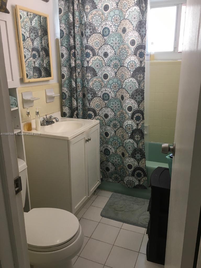 625 75th Street Miami Beach, FL 33141 - Photo 2 of 5 a bathroom with a toilet and a shower