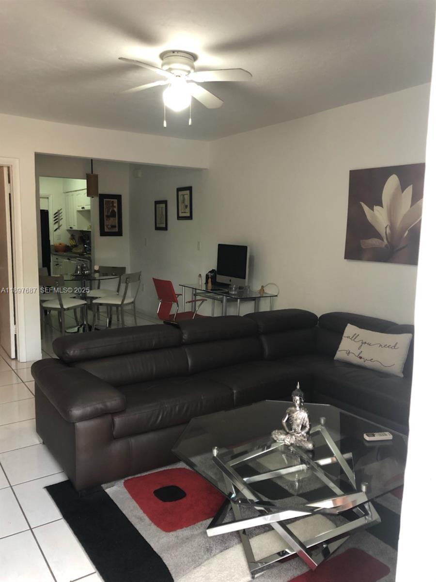 625 75th Street Miami Beach, FL 33141 - Photo 4 of 6 a living room with furniture and a chandelier