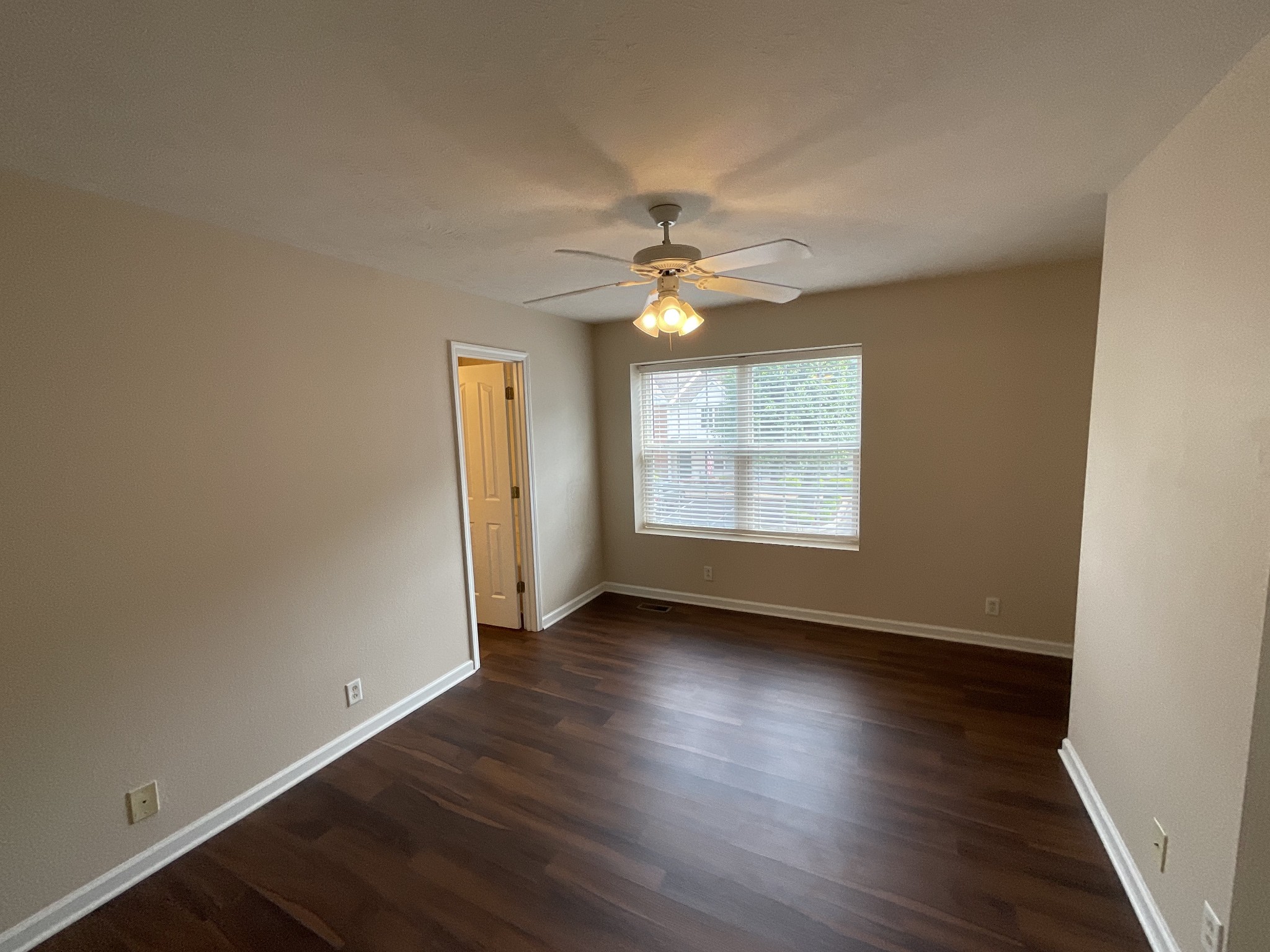 304 Shoshone Place Murfreesboro, TN 37128 - Photo 19 of 29 an empty room with wooden floor chandelier fan and windows