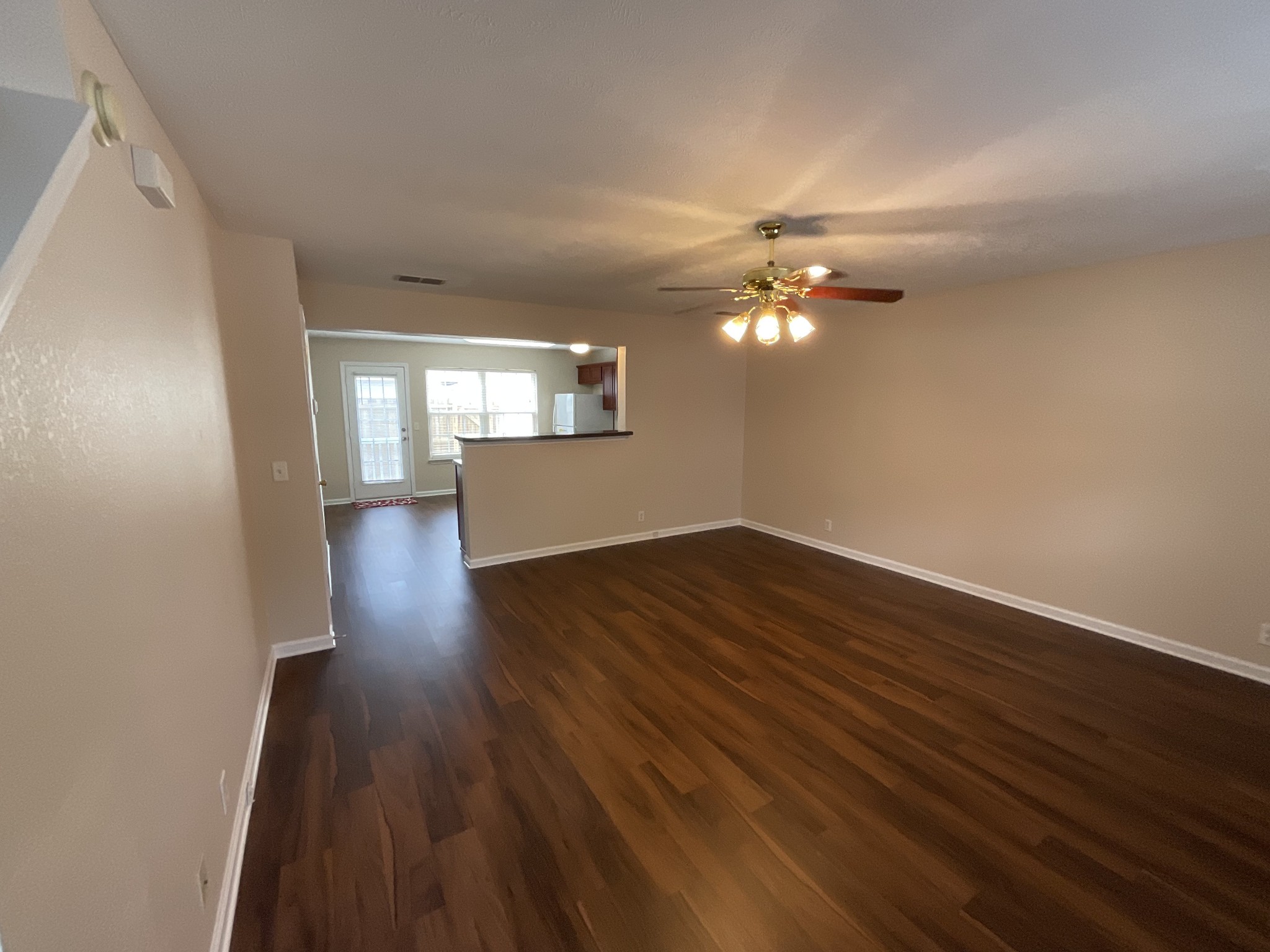 304 Shoshone Place Murfreesboro, TN 37128 - Photo 3 of 29 a view of a livingroom with wooden floor and a ceiling fan