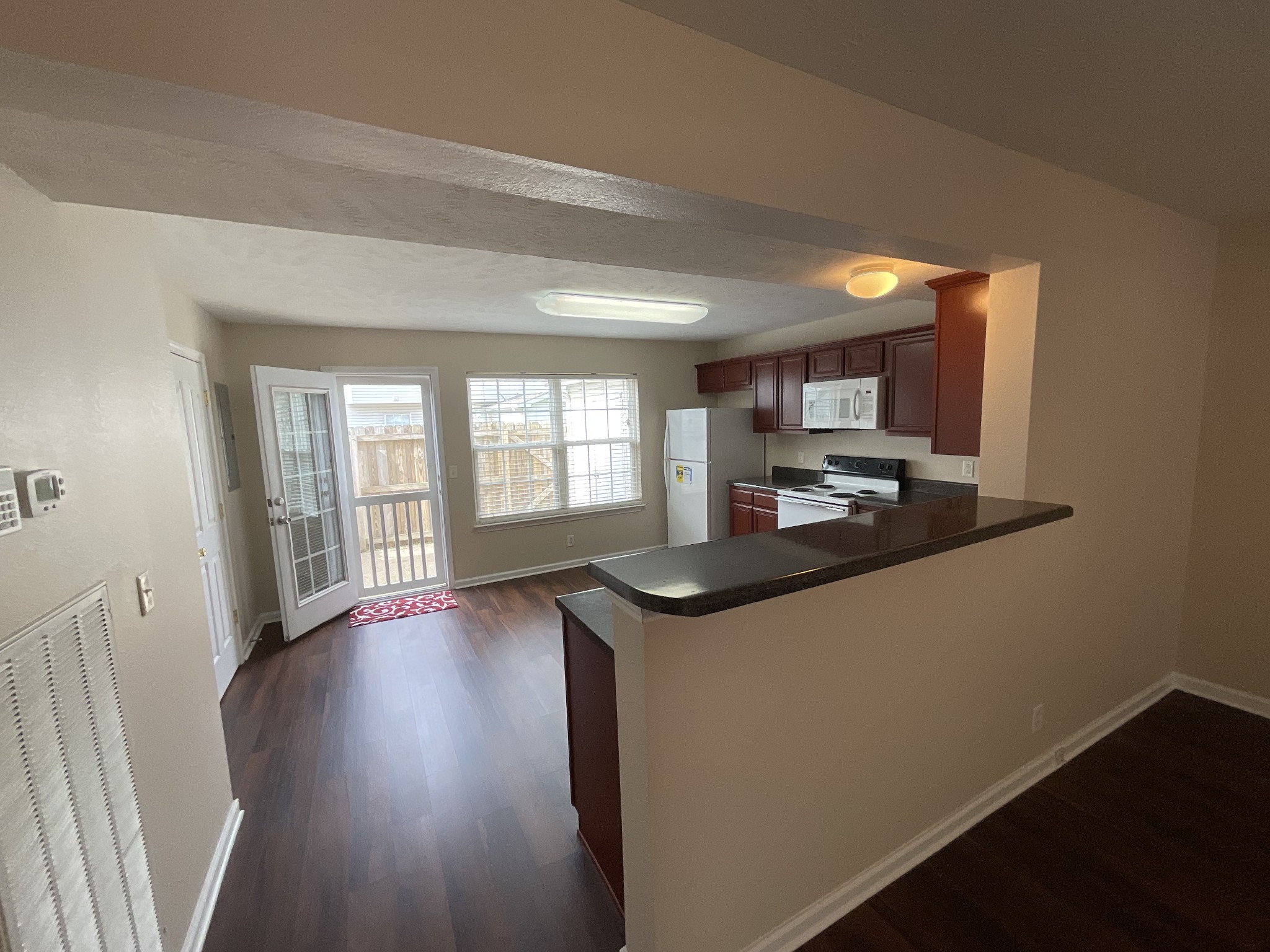 304 Shoshone Place Murfreesboro, TN 37128 - Photo 6 of 29 a kitchen with stainless steel appliances granite countertop a stove a sink and a refrigerator with wooden floors