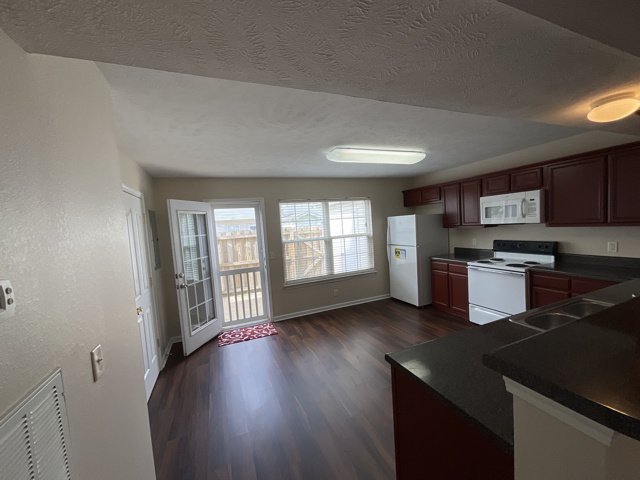 304 Shoshone Place Murfreesboro, TN 37128 - Photo 7 of 29 a kitchen with stainless steel appliances granite countertop a stove a sink a refrigerator white cabinets and wooden floor