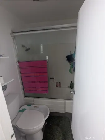 a bathroom with a toilet and a shower