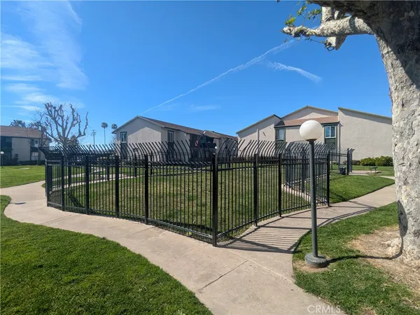 a view of a park with iron fence