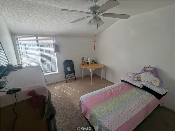 a bedroom with furniture and a window
