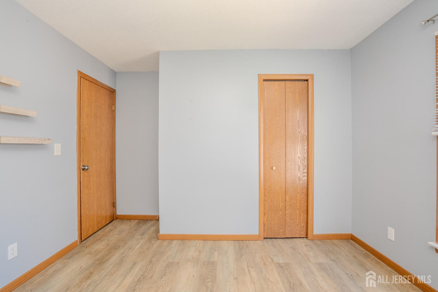 1834 Holly Road North Brunswick, NJ 08902 - Photo 15 of 26 a view of an empty room with wooden floor