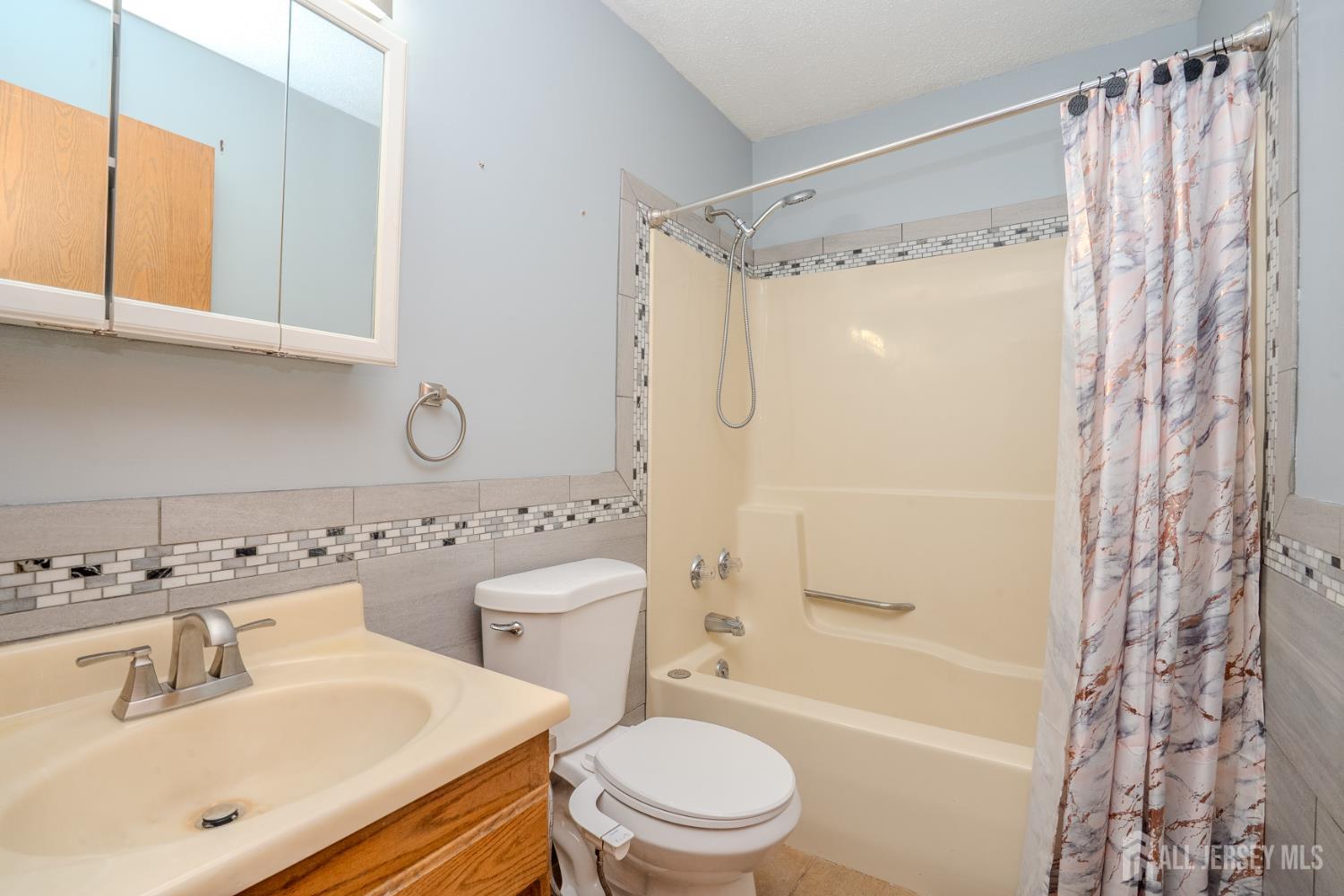 1834 Holly Road North Brunswick, NJ 08902 - Photo 17 of 26 a bathroom with a sink toilet and shower