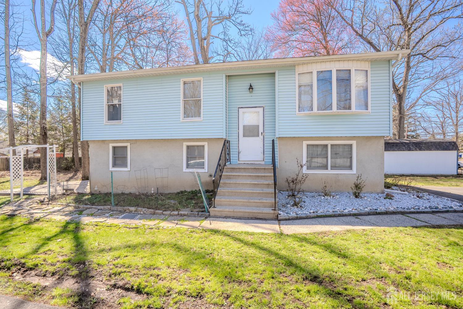 1834 Holly Road North Brunswick, NJ 08902 - Photo 2 of 26 a front view of a house with a yard