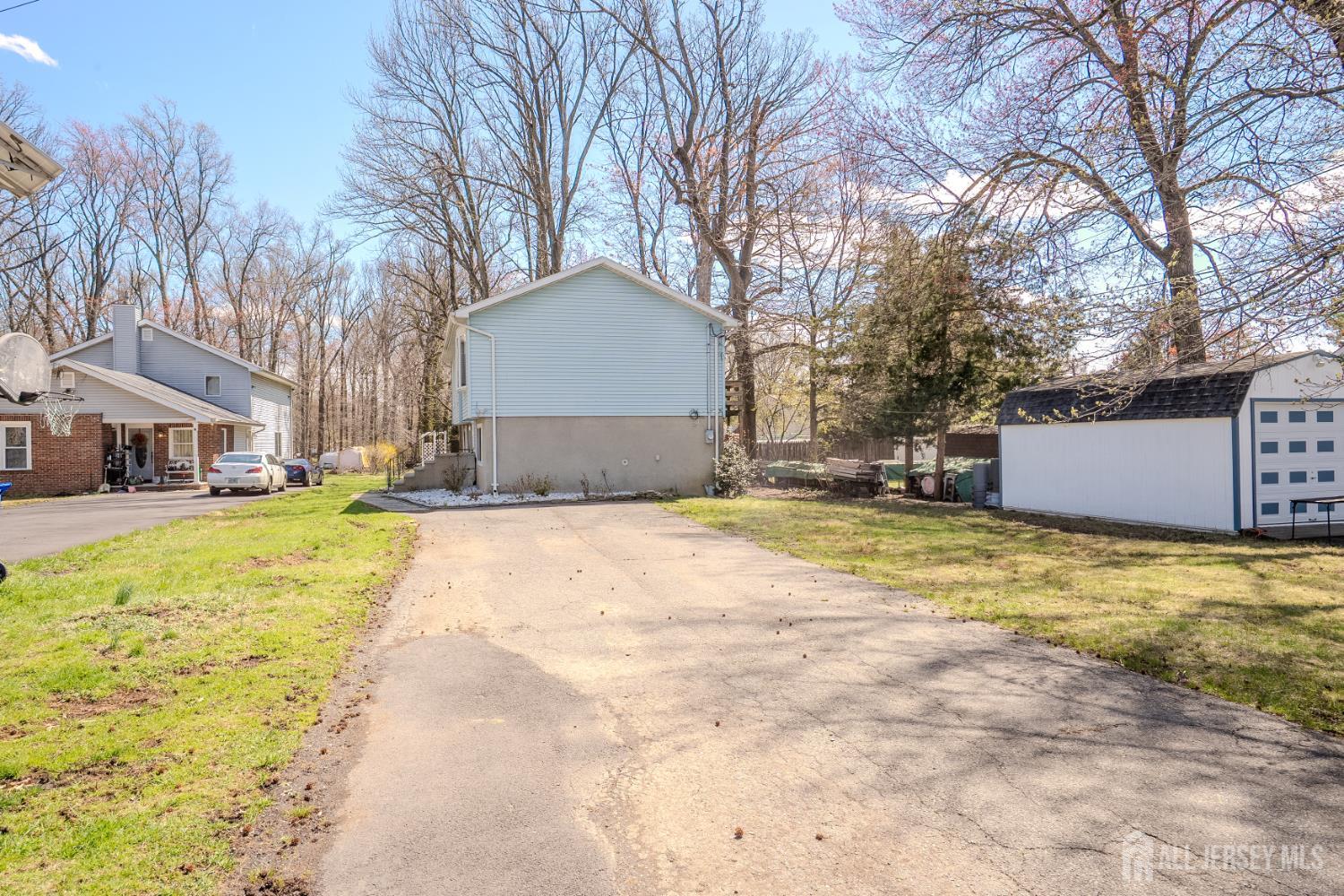 1834 Holly Road North Brunswick, NJ 08902 - Photo 21 of 26 a house with a large tree in front of it