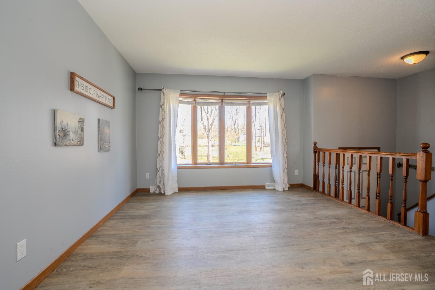1834 Holly Road North Brunswick, NJ 08902 - Photo 3 of 26 a view of a livingroom with wooden floor and a window