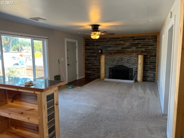 485 East 2nd Avenue Riddle, OR 97469 - Photo 8 of 25 a view of an empty room with window and fire place