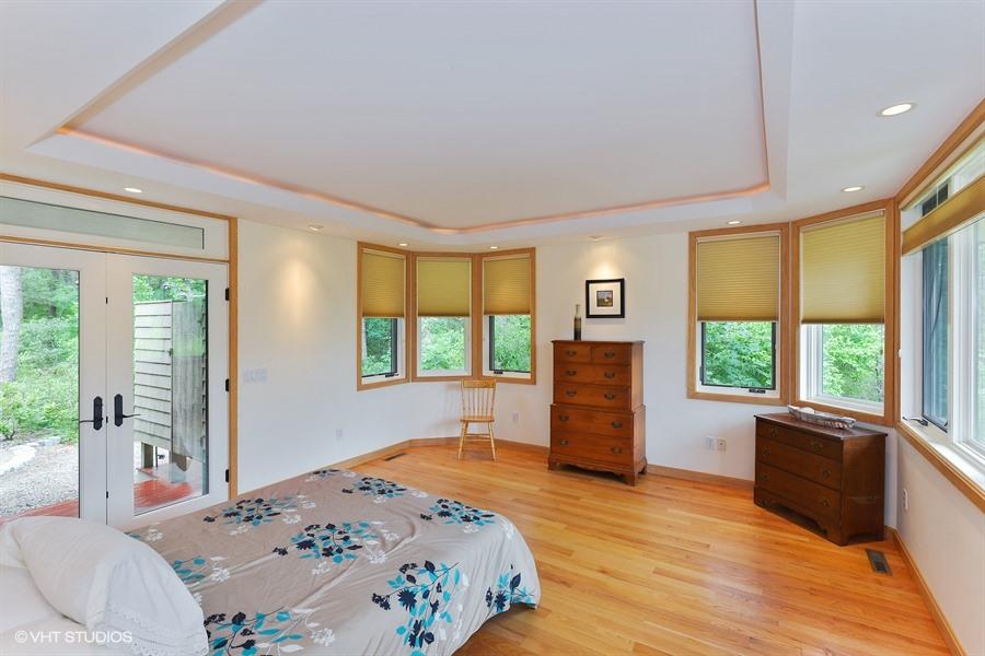5 Parker Drive Truro, MA 02666 - Photo 8 of 20 a bedroom with a bed and large windows