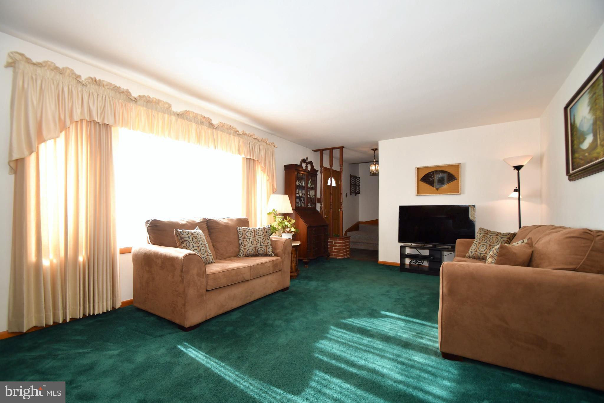 4314 Camellia Road Baltimore, MD 21236 - Photo 2 of 30 a living room with furniture and a fireplace