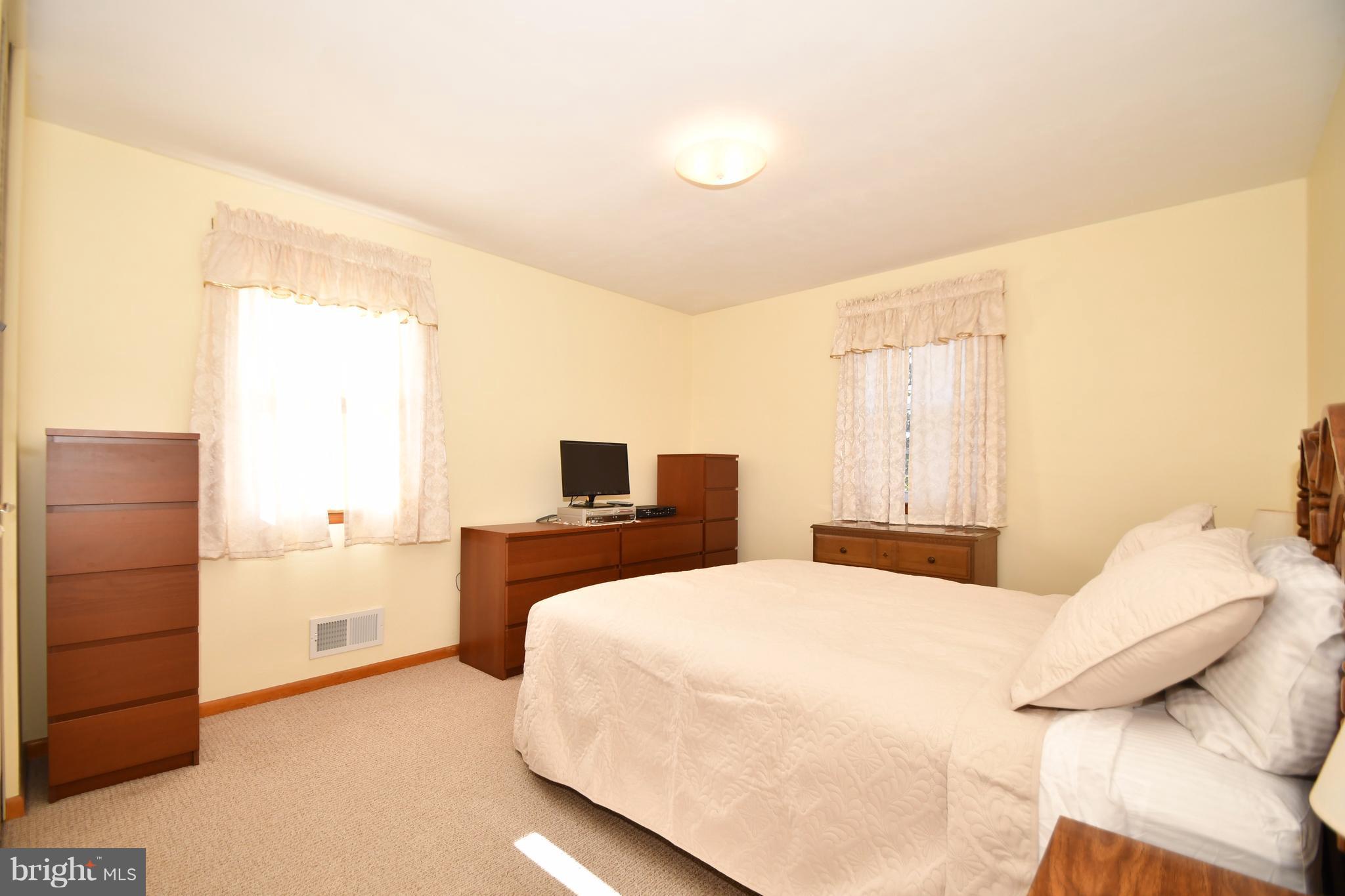 4314 Camellia Road Baltimore, MD 21236 - Photo 12 of 30 a bedroom with a bed and a night stand