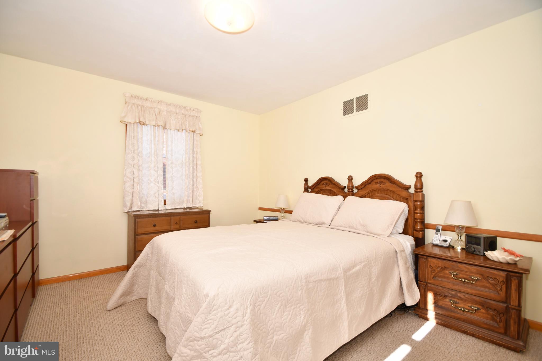 4314 Camellia Road Baltimore, MD 21236 - Photo 13 of 30 a bedroom with double bed and a night stand