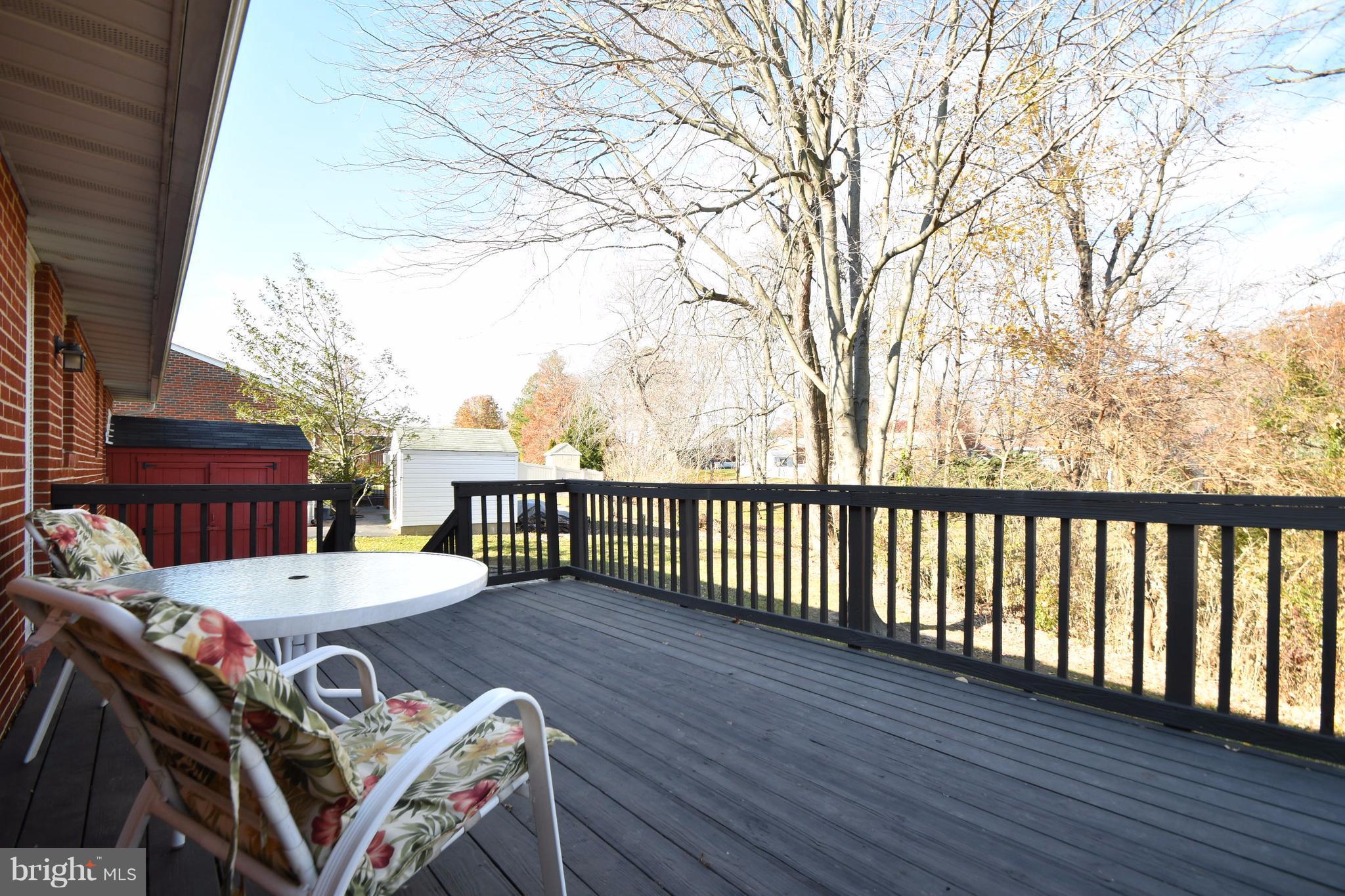 4314 Camellia Road Baltimore, MD 21236 - Photo 25 of 30 a view of a patio with table and chairs with wooden floor and fence