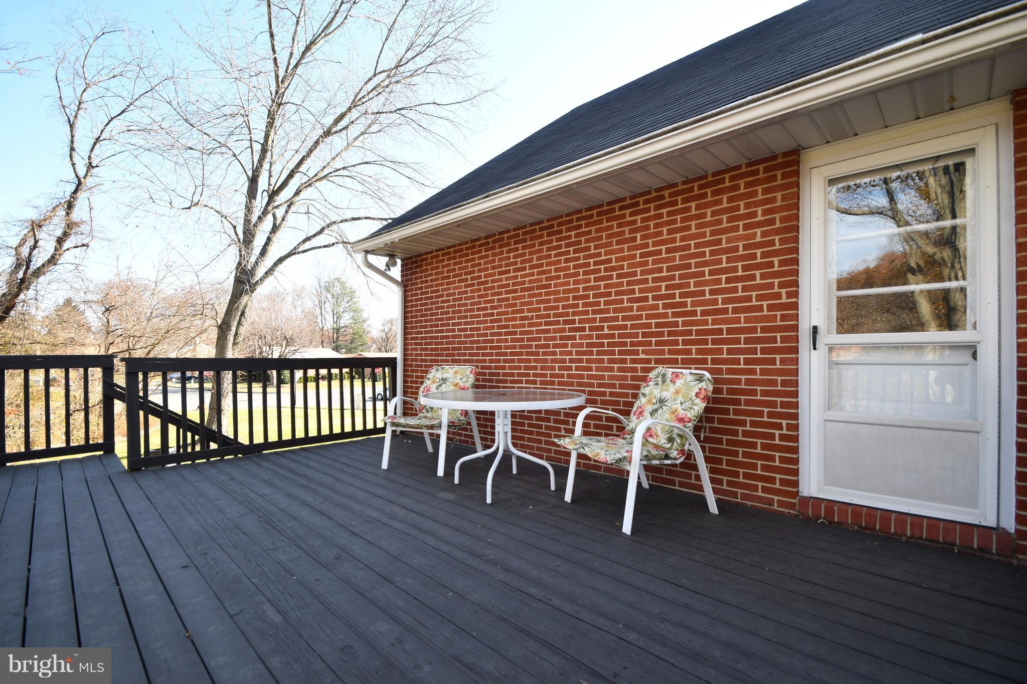 4314 Camellia Road Baltimore, MD 21236 - Photo 27 of 30 a view of a roof deck with table and chairs and wooden floor