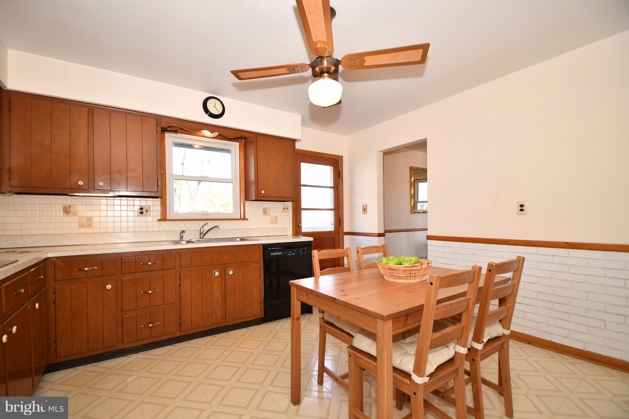 4314 Camellia Road Baltimore, MD 21236 - Photo 8 of 30 a kitchen with a dining table chairs cabinets and stainless steel appliances