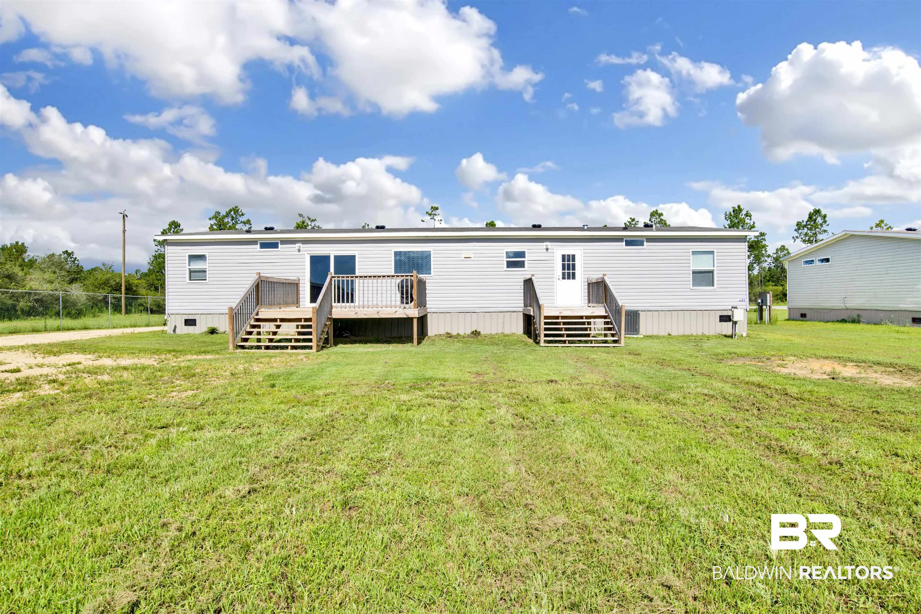 16778 County Road 87 Elberta, AL 36530 - Photo 6 of 32 Rear view of property featuring a yard and a wooden deck