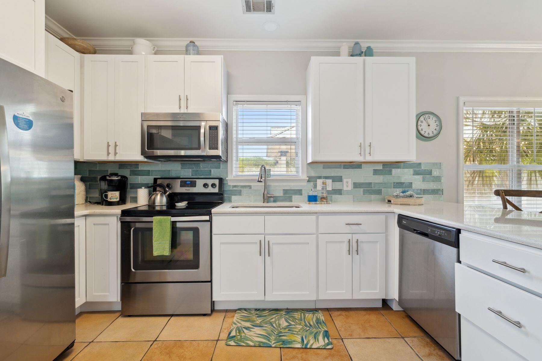 104 Emerald Dunes Circle Santa Rosa Beach, FL 32459 - Photo 14 of 53 a kitchen with granite countertop a sink stainless steel appliances and cabinets