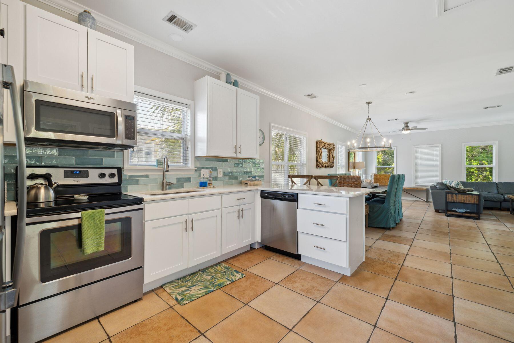 104 Emerald Dunes Circle Santa Rosa Beach, FL 32459 - Photo 15 of 53 a kitchen with a stove sink and cabinets
