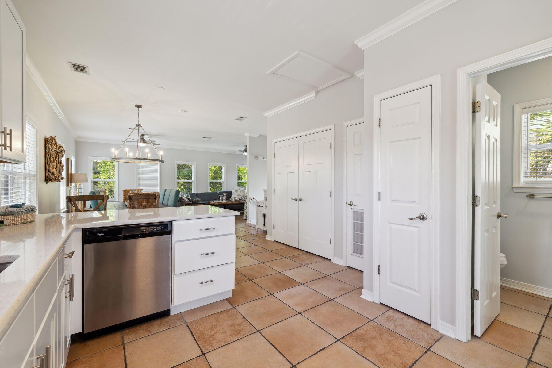 104 Emerald Dunes Circle Santa Rosa Beach, FL 32459 - Photo 16 of 53 a kitchen with white cabinets and appliances