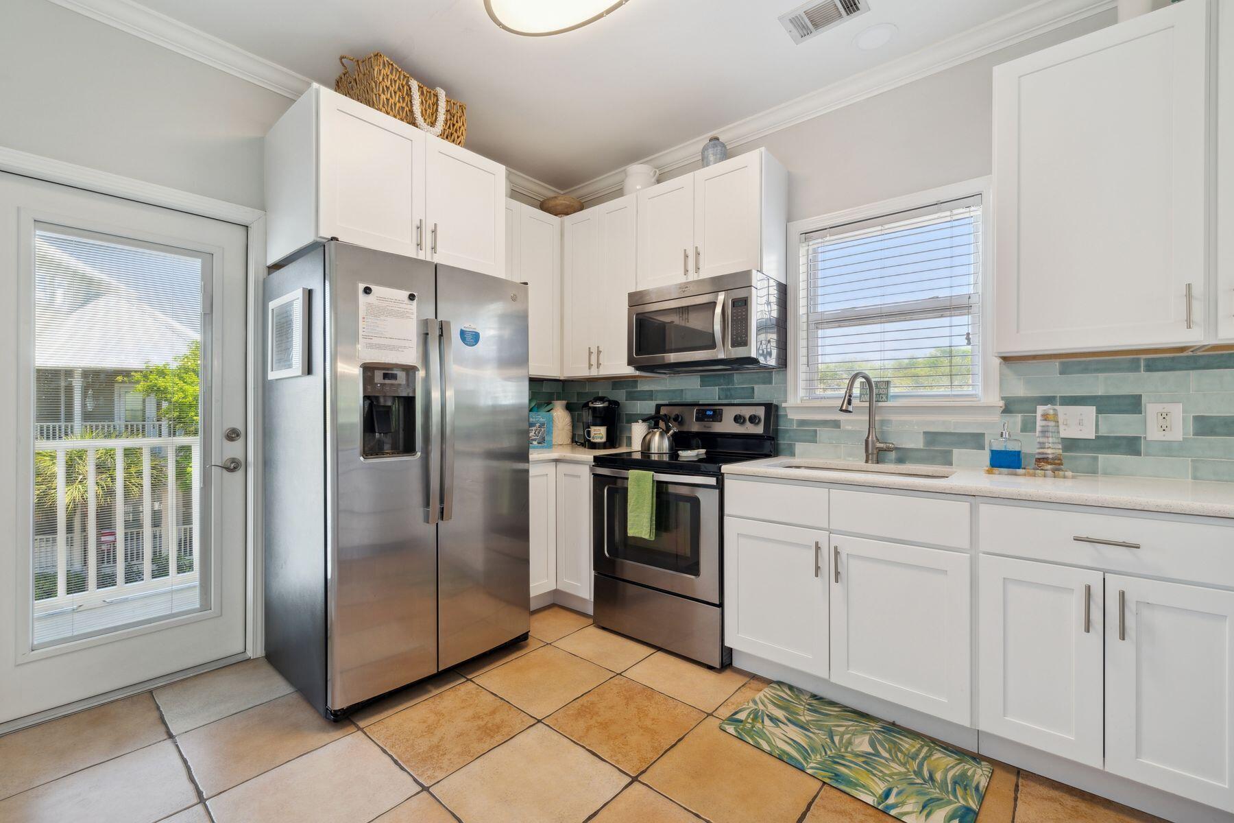 104 Emerald Dunes Circle Santa Rosa Beach, FL 32459 - Photo 17 of 53 a kitchen with stainless steel appliances a refrigerator sink and microwave