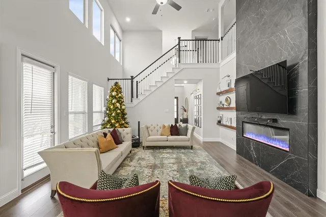a living room with fireplace furniture and a flat screen tv