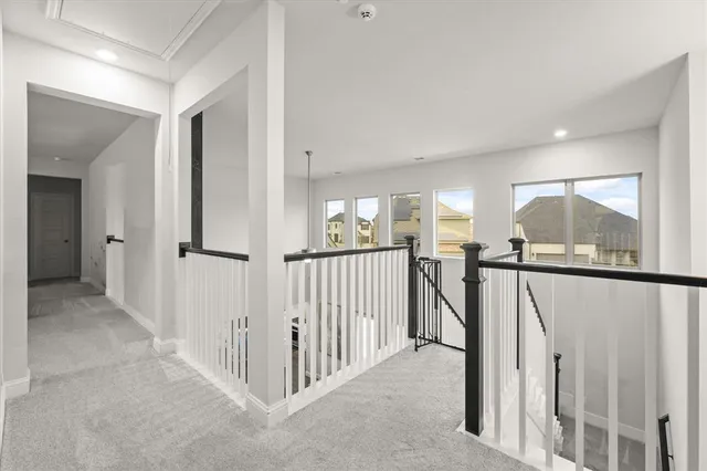 a view of a hallway with a large window and stairs