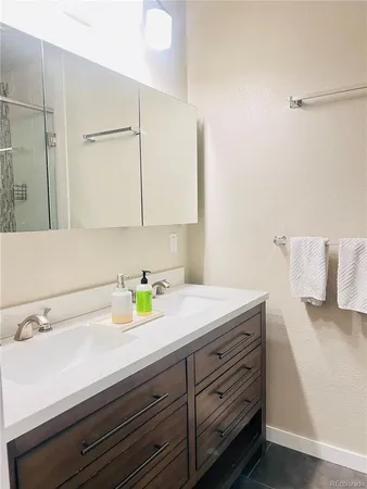 a view of a kitchen with wooden floor and a sink