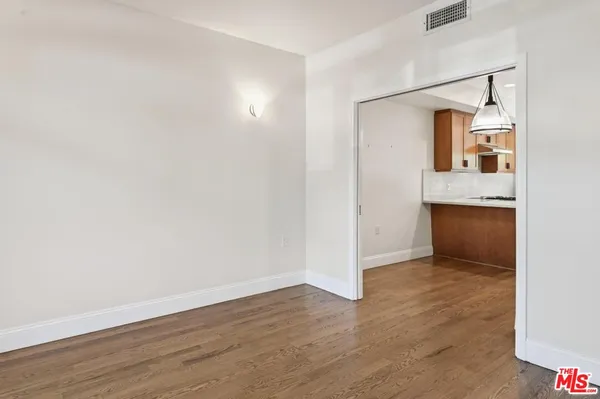 an empty room with wooden floor and closet