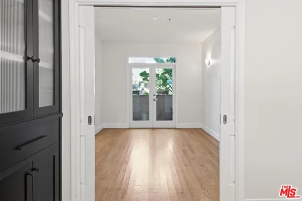 a view of a hallway with wooden floor
