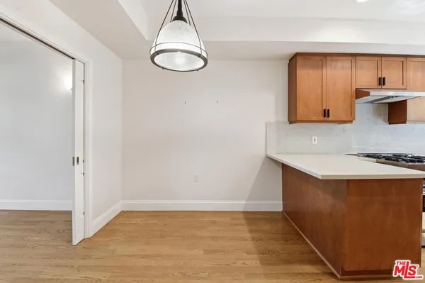 a view of a kitchen with a sink and cabinets