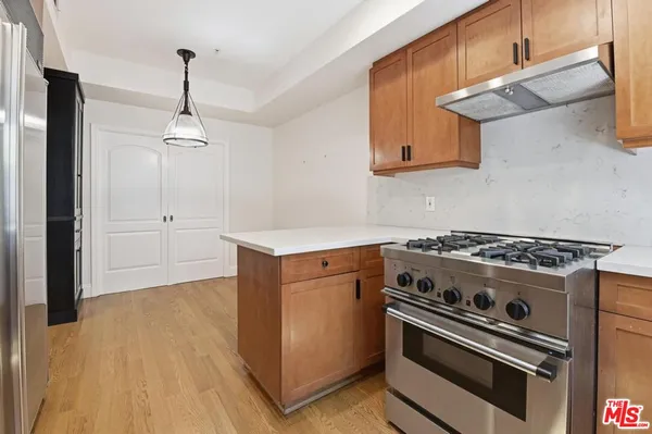 a kitchen with granite countertop a stove and a sink