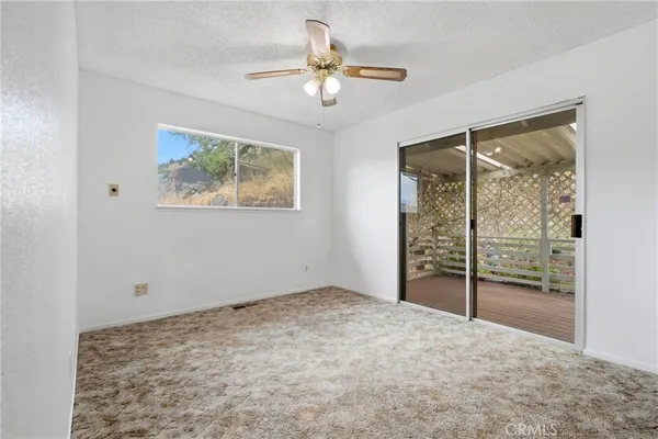 a view of a livingroom with wooden floor and furniture