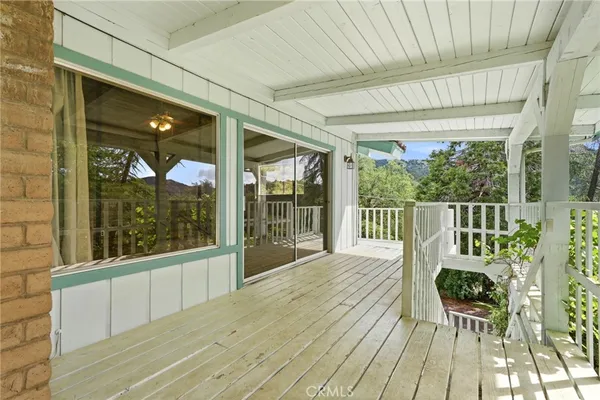 a view of a porch with wooden floor