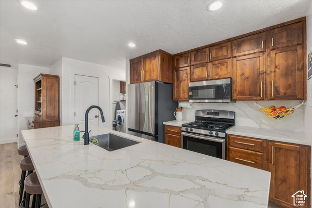437 Scenic Heights Road Kamas, UT 84036 - Photo 2 of 46 Spacious kitchen with a large island, wood-finish cabinetry, stainless steel appliances, and light-colored countertops