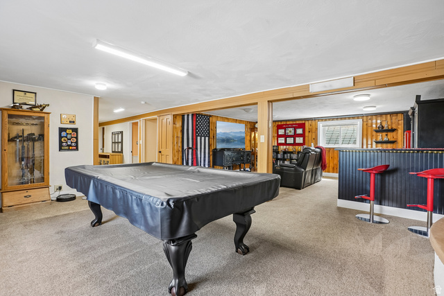 400 High Bench Road Alpine, UT 84004 - Photo 13 of 34 Carpeted recreation room featuring wood-finish paneling, a built-in bar, and recessed lighting