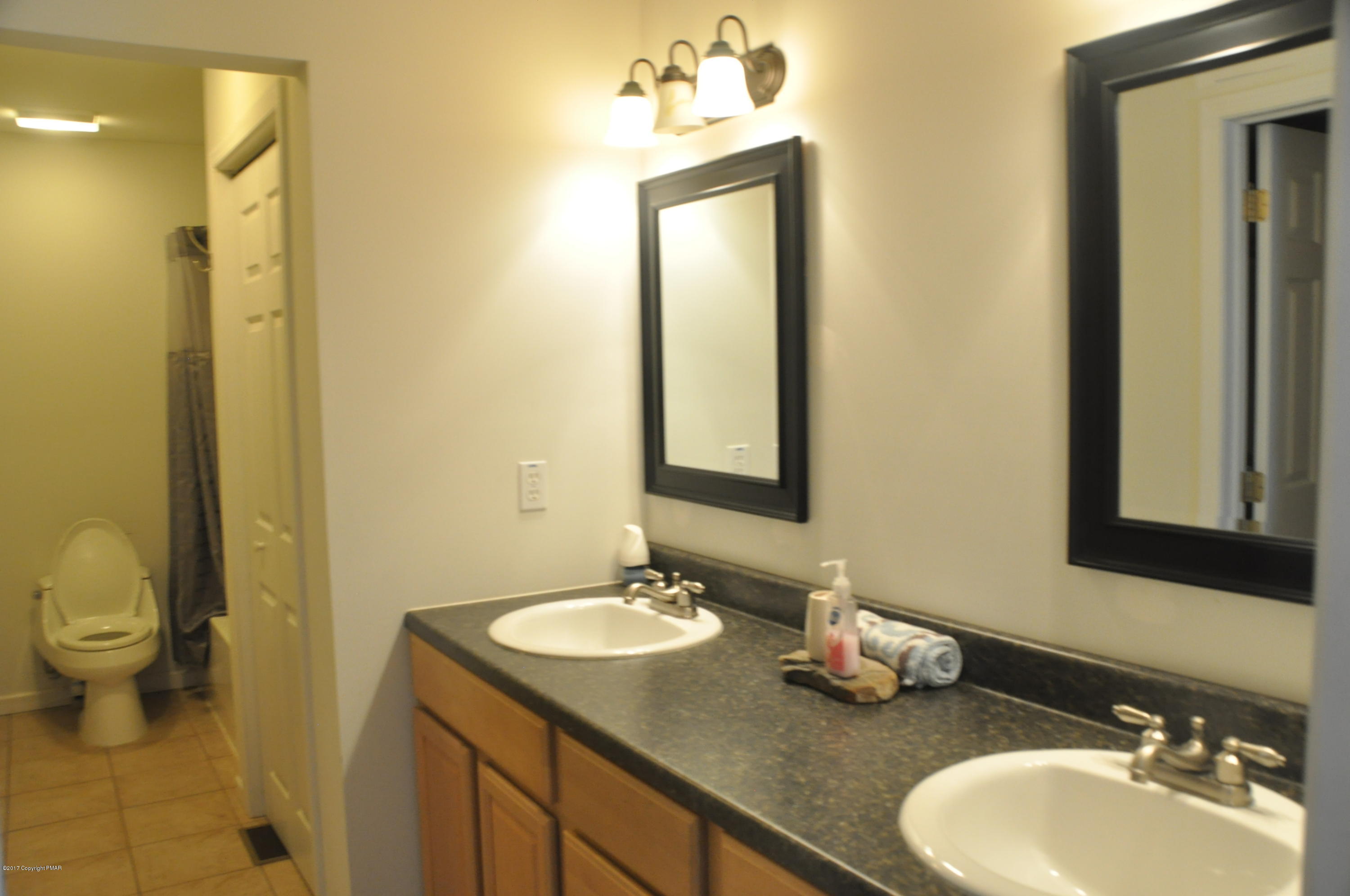 167 Sawmill Road Long Pond, PA 18334 - Photo 23 of 38 a bathroom with a granite countertop sink toilet and mirror