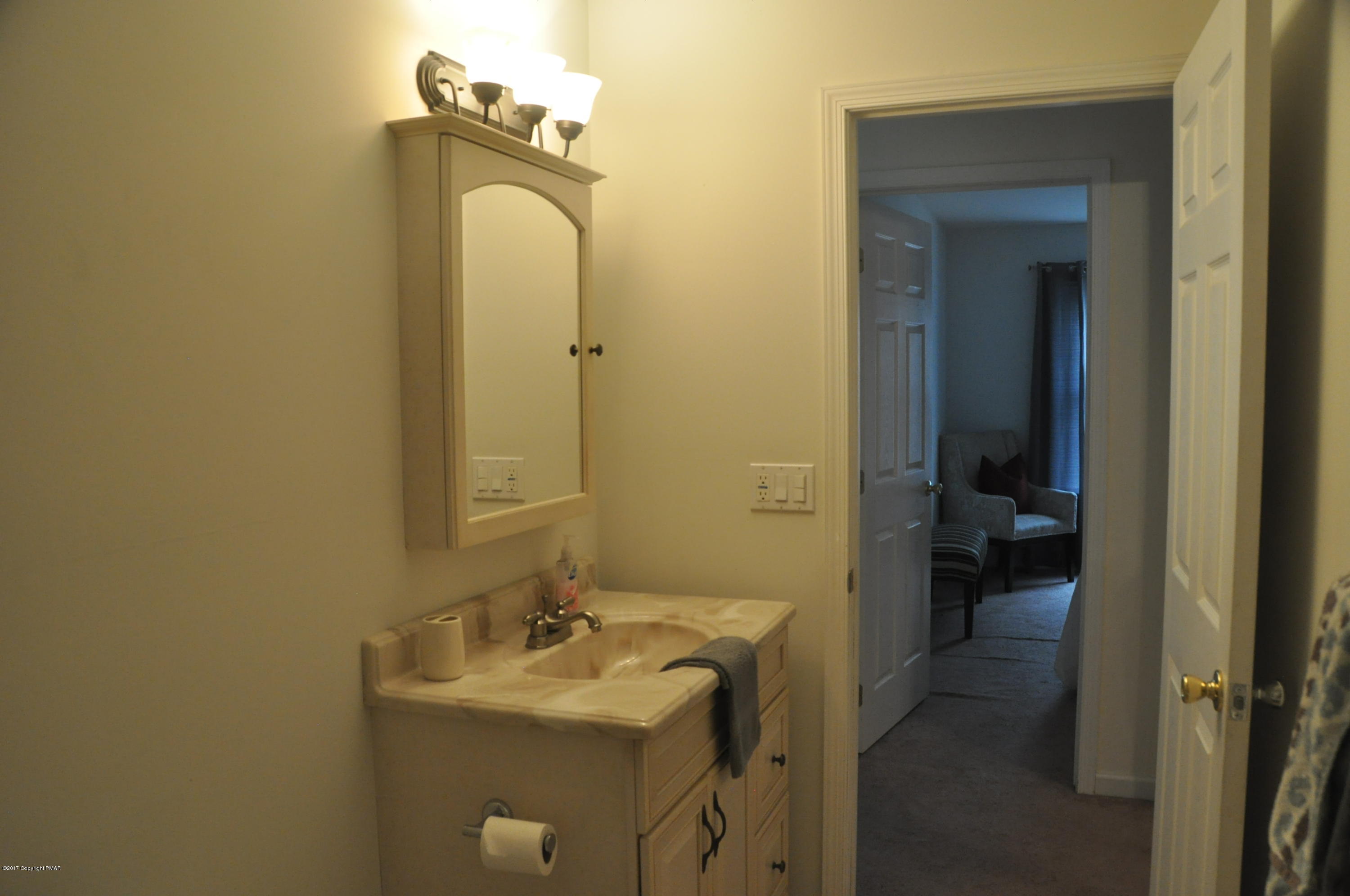 167 Sawmill Road Long Pond, PA 18334 - Photo 29 of 38 a bathroom with a sink mirror and toilet